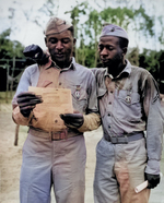 African-American US Marines Staff Sergeant Timerlate Kirven and Corporal Samuel J. Love, Sr. received Purple Heart medals during the battle for Saipan, Mariana Islands, date unknown