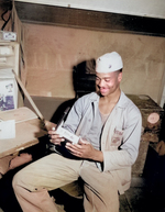 African-American US Marine 4th Ammunition Company Private First Class Luther Woodward admiring his Bronze Star medal, 17 Apr 1945; his award was later upgraded to the Silver Star