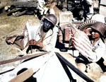 An African-American US Army soldier and a Chinese soldier placing the flag of their ally on the front of a jeep that was about to drive onto the Ledo Road/Stilwell Road, 6 Feb 1945