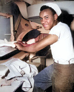 African-American US Coast Guard Seaman 1st Class Levern Robinson doing laundry aboard a troop transport in the Atlantic, circa mid-1945