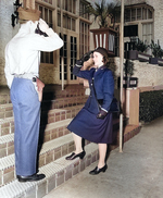 WAVES Ensign Emma D. Shelton received salute from a US Marine sentry s she enters an apartment building that served as temporary WAVES quarters, circa 1943