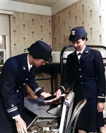 WAVES Lieutenant (jg) Harriet Ida Pickens and Ensign Frances Wills packing following graduation from the Naval Reserve Midshipmen