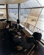 WAVES Control Tower Operator at work at  Naval Air Station, Floyd Bennett Field, New York, United States, Nov 1943; note FM Wildcat and TBM Devastator aircraft in background