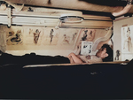 American sailor reading in his bunk aboard USS Capelin, Aug 1943