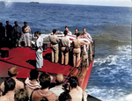 US Navy Chaplain W. M. Dunn conducting funeral service of Lieutenant (jg) Eugene Bradshaw aboard USS Coral Sea in the Pacific Ocean during the Mariana Islands campaign, 19 Jun 1944