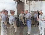 Captain George C. Montgomery awarding a citation ribbon to Aviation Ordnanceman 2nd Class Harvey J. Rowe aboard USS Anzio, 6 Jan 1945, photo 1 of 2