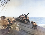 USS Anzio rolling in heavy seas, Pacific Ocean, 17 Dec 1944; note Avenger aircraft in foreground and Wildcat aircraft in background; seen in Nov 1945 issue of US Navy publication Naval Aviation News