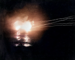 USS Helena performing night time bombardment of Japanese positions in the Munda-Vila area, New Georgia, Solomon Islands, 13 May 1943; photo taken from USS Honolulu