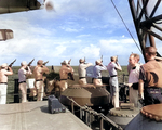 US Marines aboard USS Honolulu firing a salute during funeral services for Fireman 1st-class Irvin L. Edwards, a crew member of the sunken USS Helena who died of his wounds, 7 Jul 1943.