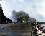 USS Intrepid damage control crews began fighting flight deck and hangar deck fires following a special attack plane crashing through the flight deck off Luzon, Philippine Islands, 25 Nov 1944