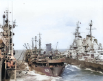 Battleship USS Iowa and carrier USS Shangri-La receiving fuel from oiler USS Cahaba, 8 Jul 1945. Photo 2 of 5.