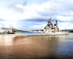 USS Iowa entering Pearl Harbor, US Territory of Hawaii with her rails manned as she prepares to pass the sunken USS Arizona, 28 Oct 1952