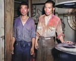 Two survivors of the sunken Jintsu, dressed in US Navy uniforms, aboard USS Nicholas (DD-449), 13 Jul 1943