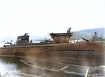 Incomplete Japanese submarine Ha-230 at Sasebo, Japan, 19 Oct 1945; note carrier Junyo (center), carrier Ibuki (center background, beyond Junyo), incomplete Unryu-class carrier Kasagi (right background), and a number of escort ships (left background)