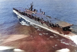 USS Langley underway off Cape Henry, Virginia, United States, 6 Oct 1943; note SNJ aircraft on flight deck