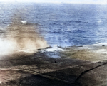 Damage to Lexington after bomb hit near the port forward 5-inch gun gallery, Battle of Coral Sea, 8 May 1942, photo 1 of 4