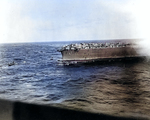 A whaleboat and a motor launch evacuated Lexington, 8 May 1942; TBD, SBD and F4F aircraft could be seen on the flight deck