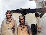 US Navy aviators Ensign William C. Orr and Aviation Radioman 3rd Class Thomas D. Everett of cruiser Louisville posed by their damaged SOC Seagull aircraft, Feb 1945