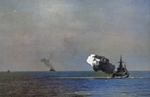 USS North Carolina firing her main guns, circa 1944; note shells in flight at left of photograph