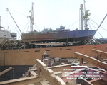 PT-109 stowed on board the Liberty Ship Joseph Stanton for transportation to the Pacific Ocean, Norfolk Navy Yard, Virginia, United States, 20 Aug 1942, photo 1 of 2