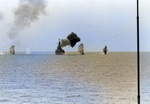 USS Saint Paul bombarding the Cong Phy railroad yard 25 miles south of Thanu Hoa, Vietnam, 4 Aug 1967; note splashes from coastal gun batteries