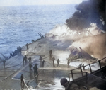 Following an attack from Japanese special attack aircraft, fires grew in the forward hangar deck of USS Saratoga off Iwo Jima, 21 Feb 1945. The fires increased greatly before they could be controlled. Photo 2 of 3