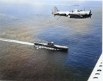 SBD Dauntless aircraft flying over USS Enterprise (foreground) and USS Saratoga (background), off Guadalcanal, Solomon Islands, 19 Dec 1942