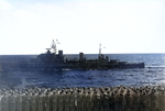 The cerws of USS Saratoga (foreground) and HMNZS Gambia (center) saluting each other as USS Saratoga was preparing to leave Indian Ocean, 18 May 1944