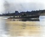 Skipjack running up Thames River after departing the Electric Boat Company shipyard at Groton, Connecticut, United States to go to the Naval Submarine Base for commissioning ceremonies, 30 Jun 1938