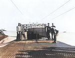 Crew of USS Snook holding up the submarine