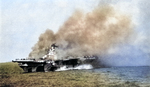 USS Ticonderoga burning after being hit by two special attack aircraft, 125 miles east-southeast of Taiwan, 21 Jan 1945