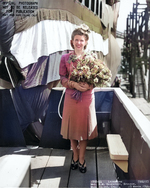 Mrs. Davenport, wife of future commanding officer of Trepang, posing with the submarine at its christening, Mare Island Naval Shipyard, California, United States, 23 Mar 1944