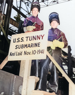 W. N. Simons and Robert F. Cooke, honorary keel layers of submarine Tunny, posing with the sign at Mare Island Naval Shipyard, California, United States, 10 Nov 1941