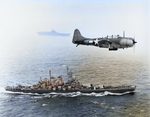 SBD-5 Dauntless aircraft flying over USS Washington and USS Lexington in the Pacific Ocean en route toward the Gilbert Islands, 12 Nov 1943