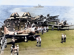 SBD-3 Dauntless, F4F-4 Wildcat, and TBF-1 Avenger aircraft aboard USS Enterprise, northeast of Nouméa, New Caledonia, 2 May 1943; note USS Washington in background