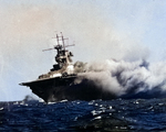 Wasp (Wasp-class) burning and listing after being torpedoed by Japanese submarine I-19 in the South Pacific, 15 Sep 1942. Photo 1 of 2.