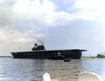 Yorktown arrived at Pearl Harbor after the Battle of Coral Sea, 27 May 1942, with her crew paraded in whites on the flight deck