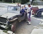 US Army Captain Thomas Ryan checking in civilian photo technicians at a checkpoint in Potsdam, Germany, 14 Jul 1945; note Willys MB jeep; the military policeman was Corporal Charles Christie