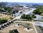 Japanese surrender ceremony at the headquarters of US 10th Army, Okinawa, Japan, 7 Sep 1945; note Japanese guns by flagpole, US M26 heavy tanks lower left, US self-propelled guns upper left