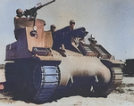 M7 self-propelled artillery vehicle being tested for desert warfare near Iron Mountain, California, United States, circa 1940; the men were Corporal Downing (left, manning machine gun), Corporal L. Roberts (center, manning howitzer), and Lieutenant M. Hutchison (right); photo 1 of 2