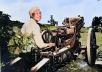 A Chinese soldier posing next to a M1A1 75-mm Pack Howitzer atop M1 carriage, circa 1942