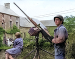 American soldiers with Browning M2HB machine gun in a town in Normandy, France, 1944