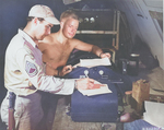 Americans at work at a base on Saipan, Mariana Islands, 1945; note M3 Fighting Knife on the non-commissioned officer