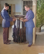 US Army Privates Kotula and Queen hanging stockings on Springfield M1903 rifles for the Christmas season, Camp Lee, Virginia, United States, Dec 1941