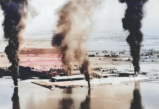 Seaplane hangars under US Navy carrier aircraft attack, Toko Bay (now Dapeng Bay), southern Taiwan, 12 Oct 1944, photo 3 of 7 [Colorized by WW2DB]