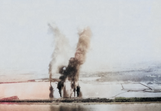 Seaplane hangars under US Navy carrier aircraft attack, Toko Bay (now Dapeng Bay), southern Taiwan, 12 Oct 1944, photo 6 of 7 [Colorized by WW2DB]