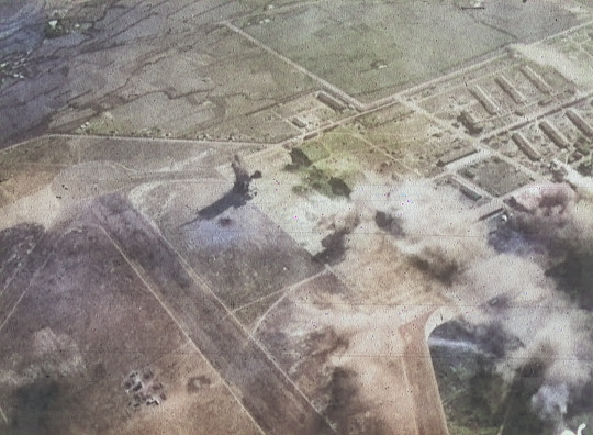 Shinchiku Airfield under US Navy carrier aircraft attack, Taiwan, 12 Oct 1944, photo 1 of 2 [Colorized by WW2DB]