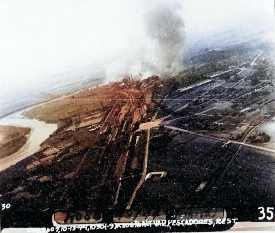 Rail marshaling yard at Shinei District (now Xinying District), Tainan, Taiwan under carrier air attack, 13 Oct 1944; note original caption was mis-labeled [Colorized by WW2DB]