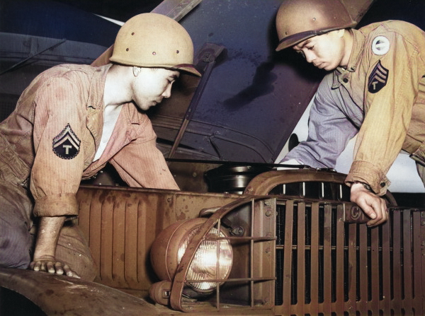 Japanese-American recruits of US 100th Infantry Battalion repairing engine of a 5x6 Army truck while training at Camp Shelby, Mississippi, United States, 1943 [Colorized by WW2DB]