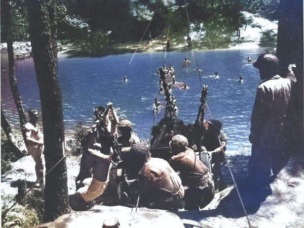 Japanese-American recruits of anti-tank company of US 442nd Regimental Combat Team ferrying a gun across a stream during training at Camp Shelby, Mississippi, United States, 6 Sep 1943 [Colorized by WW2DB]